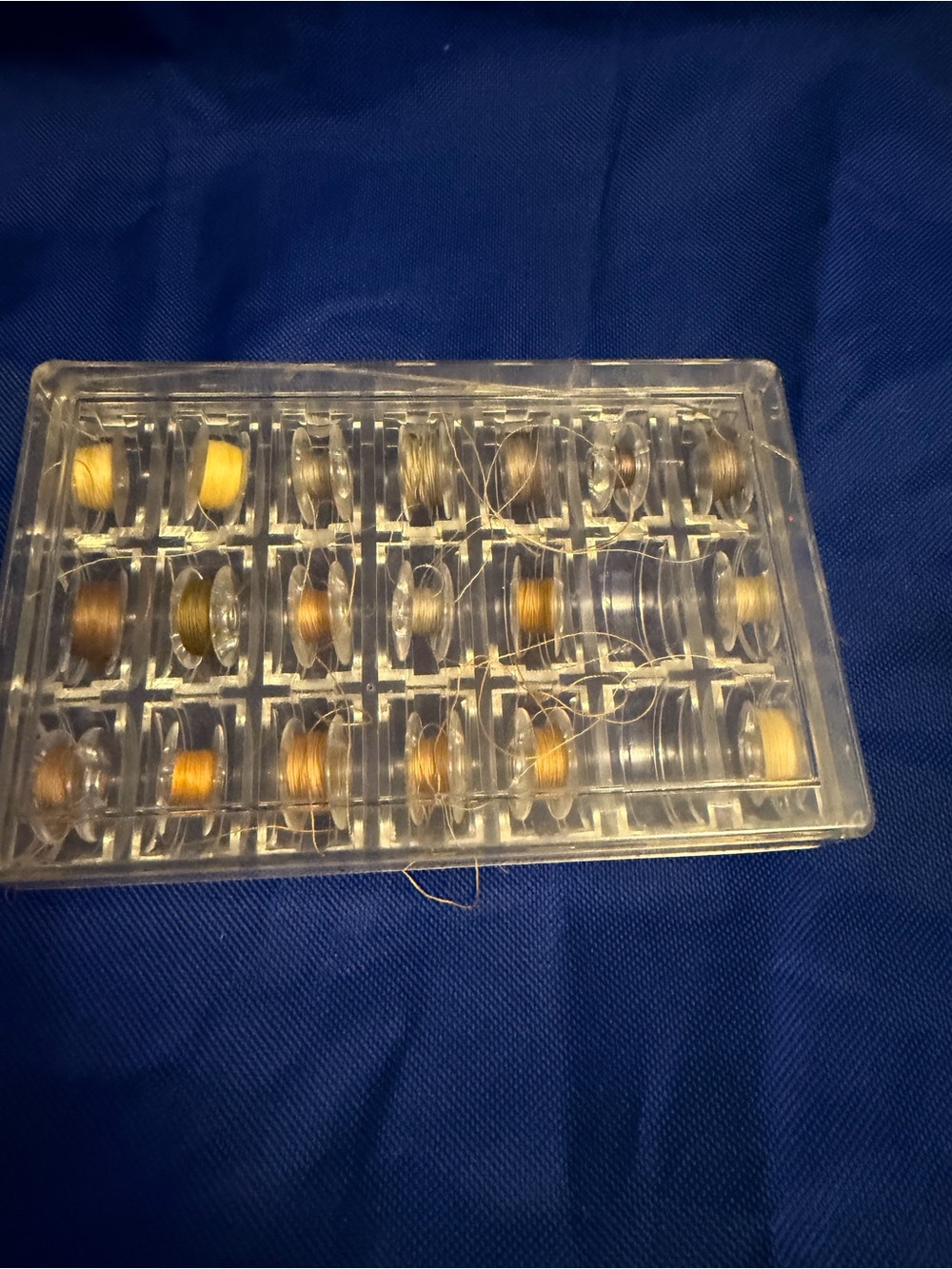 Source Unknown Sewing Machine Bobbins Set in Gold and Brown Tones